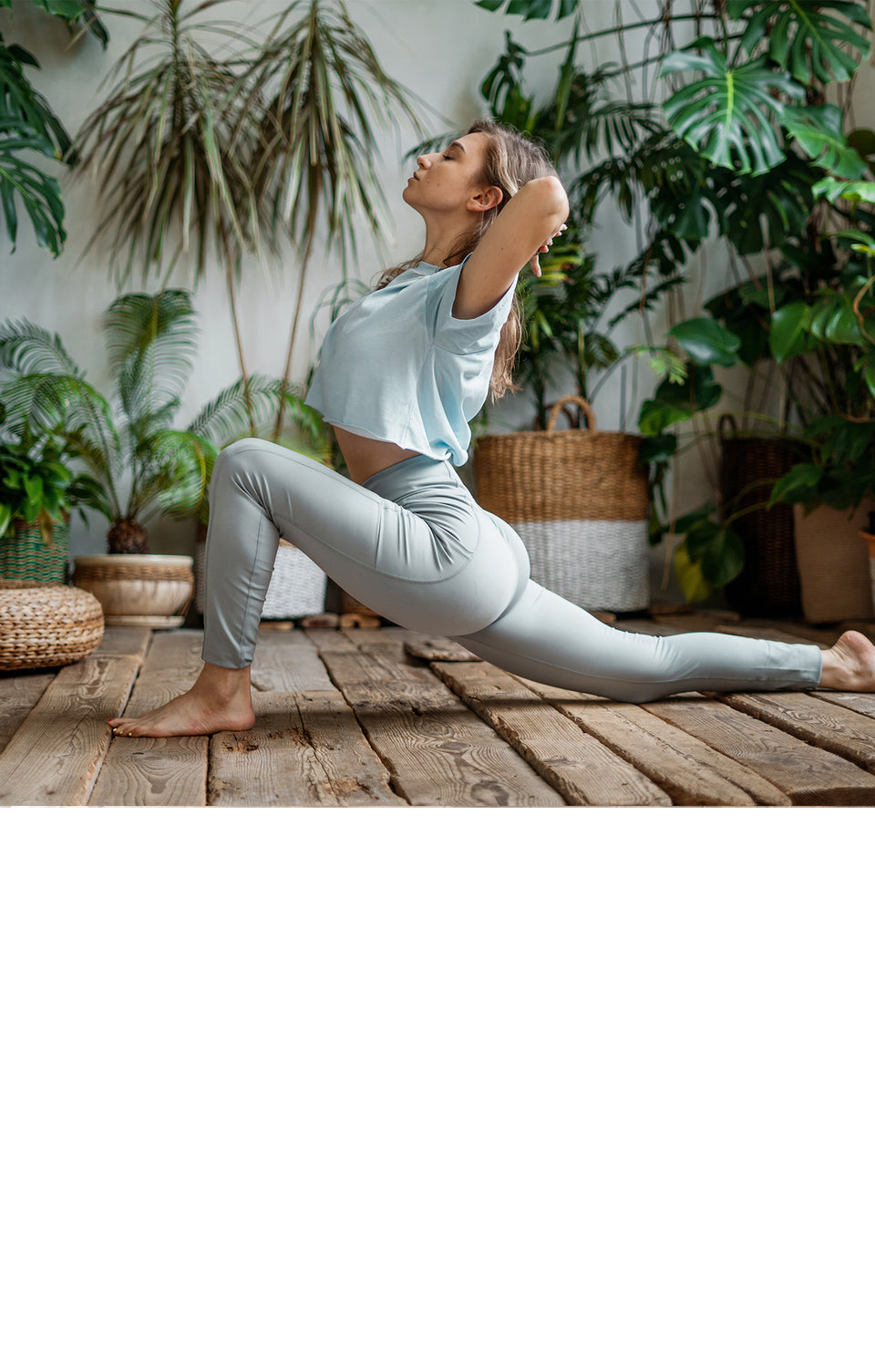  Woman practicing yoga in a room with plants.